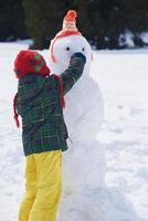 boy making snowman photo