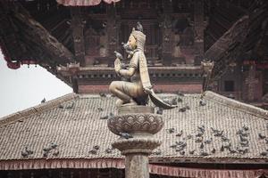 The garuda statue on the pillar of Bhaktapur or Bhadgaon the city of Devotees, Nepal. The Durbar Square is one of the UNESCO World Heritage Sites of the valley. photo