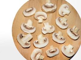 Champignons on a cutting board. Kitchen utensils photo