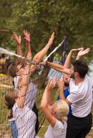 group of young friends playing Beach volleyball photo