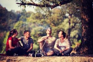 friends smoking hookah on the river bank photo