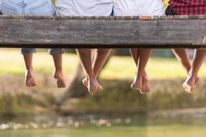 people sitting at wooden bridge photo