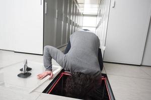 engineer connecting cables in server room photo