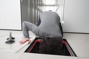 engineer connecting cables in server room photo