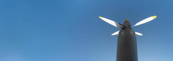 Airplane propeller of military aircraft, copy space. Blue sky background. photo