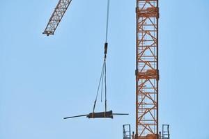 Construction crane working on building complex photo