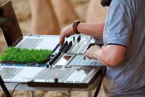 Disc jockeys DJs hands playing music on drum machine midi controller, beat sample, drum pads photo