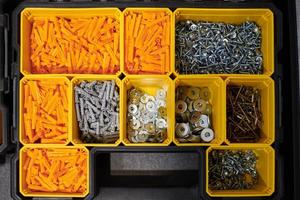 Storage case with screws, nuts, bolts, nails and other small tools for repairer, top view photo