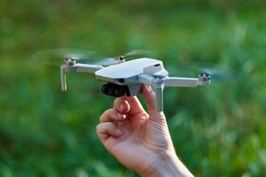 Quadcopter drone on operator hand photo