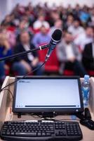 laptop computer and microphone at podium photo