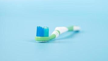 toothpaste and brush on a blue background, oral and dental care concept photo