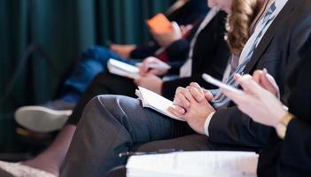 close up of business people taking notes photo