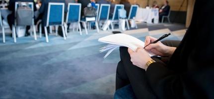 close up of business people taking notes photo