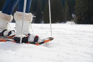 couple having fun and walking in snow shoes photo