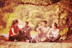 friends smoking hookah on the river bank photo