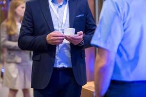 closeup of businessman holding a cup of coffee photo