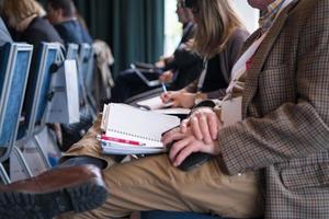 close up of business people taking notes photo