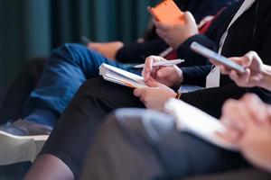 close up of business people taking notes photo