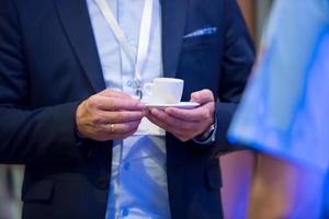 closeup of businessman holding a cup of coffee photo