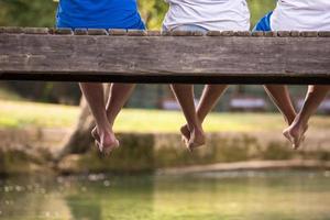 people sitting at wooden bridge photo