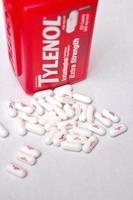 WASHINGTON, USA  July 21 2022  Bottle Of Tylenol Extra Strength With Many Pills On A Wooden Table Which Was Sold Out During Covid-19 time, headache, Painkillers photo