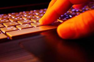 man using laptop, searching web, browsing information, having workplace at home, soft focus picture, Vintage concept, night photo
