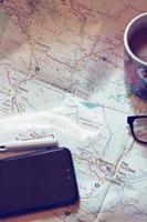 Map, map of Washington state, pen, glasses, cell phone, coffee cup on the table. photo