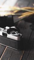 Retro film camera and negative film on a black wooden table photo