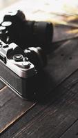 cámara de película retro y película negativa sobre una mesa de madera negra foto