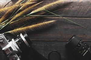 Negative film on a black wooden table and 2 vintage film cameras. photo