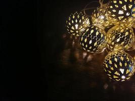 Christmas lights ball decor on wood table. photo