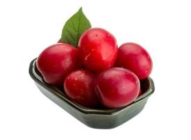 Damson plum in a bowl on white background photo