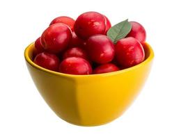 Damson plum in a bowl on white background photo