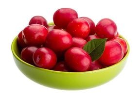 Damson plum in a bowl on white background photo