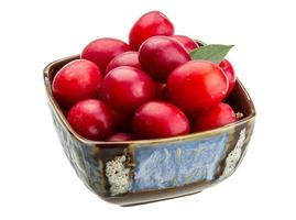 Damson plum in a bowl on white background photo