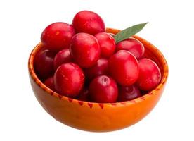 Damson plum in a bowl on white background photo