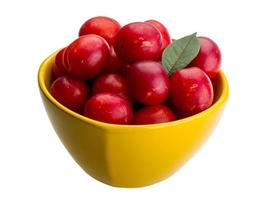 Damson plum in a bowl on white background photo