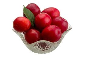 Damson plum in a bowl on white background photo