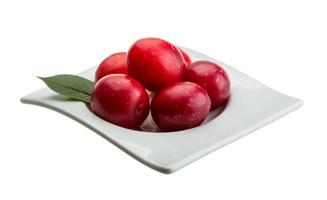 Damson plum in a bowl on white background photo