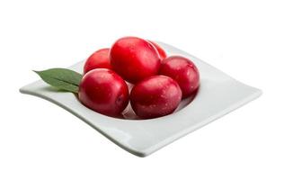 Damson plum in a bowl on white background photo