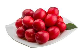 Damson plum on the plate and white background photo