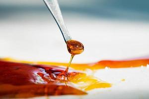 orange cannabis concentrate wax close up, high thc dab resin photo