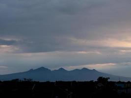 mountains and rice fields in the morning with cloud-blocked sunlight photo