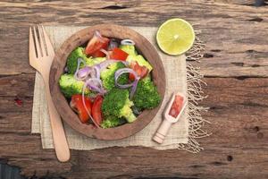 Healthy food vegetable broccoli salad in bowl on wood background. photo