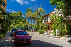 PLAYA DEL CARMEN, MEXICO - APR 2022 red Volkswagen Jetta VII 7 near the palms on a sunny day photo