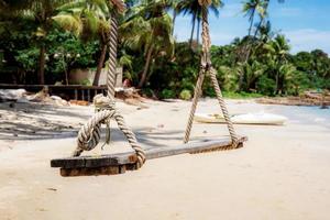 Swing on sand beach. photo
