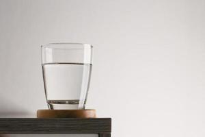 Glass of water on table photo