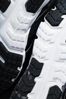 The black and white sole of trendy sports sneakers is a close-up in full screen. photo