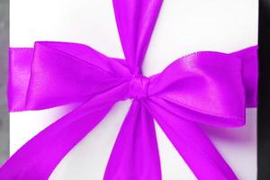Pink bow on a gift made of fabric on a white background. photo