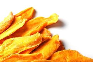 Dried mango sliced on a white background with free space photo